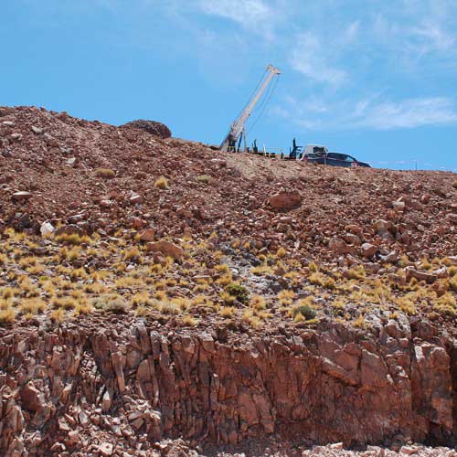 Main Breccia outcrop with drill rig in background 
